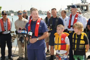 People Wearing Life Vests on a Pier